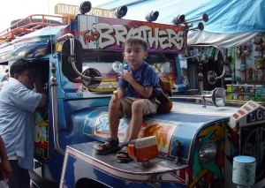 The owner/driver of the jeepney was totally at ease with me posing my son on his vehicle. I don't recommend trying this with a London cabbie.